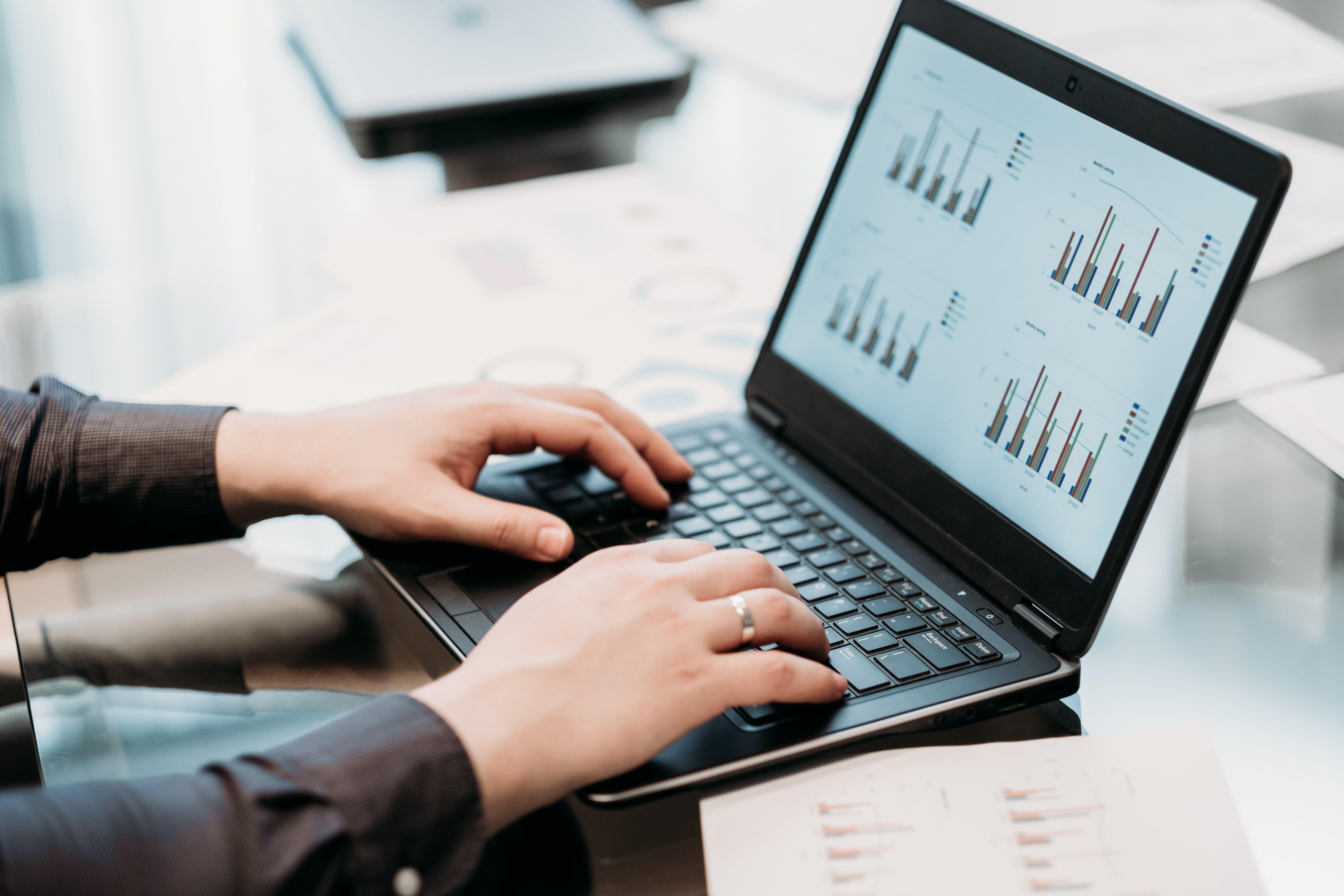 business document hands typing graph screen